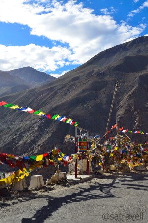 Prayer Flags, Wheels and a small shrine on the road