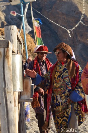 Head lamas ceremonially rotating the prayer wheels, part of the Sacred Compound, to mark the beginning of marriage functions