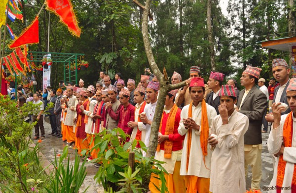 The locals with conch shells in their hands; the religious ceremonial trumpet is believed to drive off the evil spirits