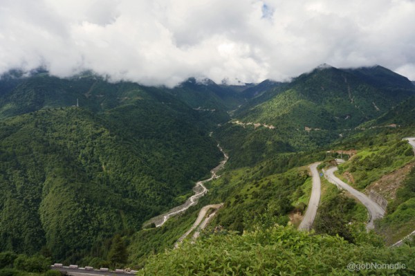 The road climbing down in loops to reach the green Chumbi Valley floor at Yadong