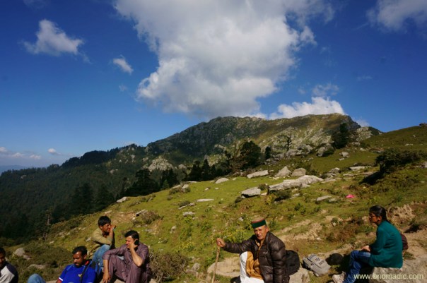 Panditji and a group of pilgrims resting at the last water refill site ahead of teesri against the backdrop of Choor